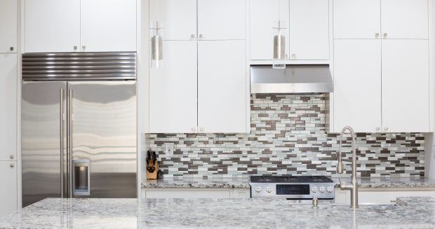 Snapshot of interior modern kitchen with granite countertop island and smart refrigerator